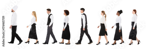Young Restaurant Staff Walking In Row