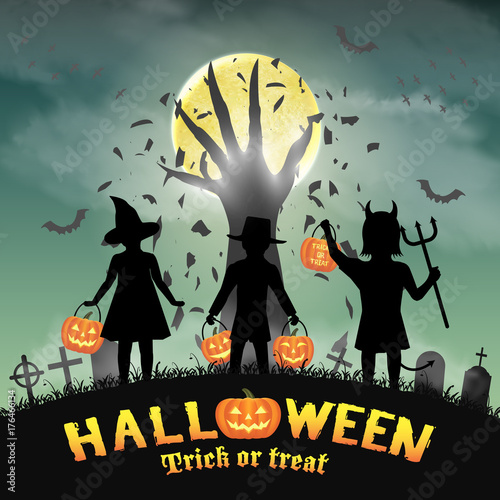 halloween kids in front of devil hand in graveyard