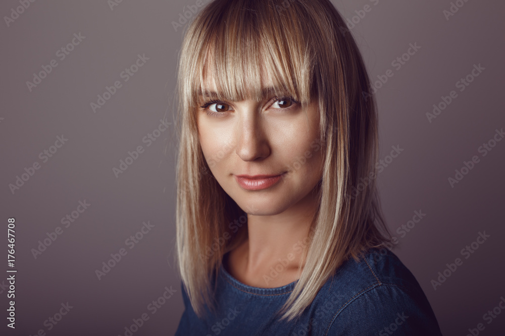 Obraz premium Closeup portrait of beautiful young middle age blonde Caucasian woman looking in camera. Girl female with long blonde hair bob studio beauty shot.