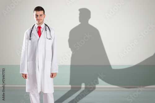 Doctor With Superhero Shadow On Wall