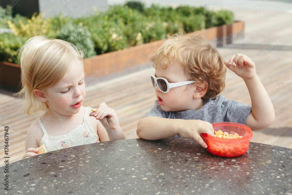 Group portrait of two white Caucasian cute adorable funny children toddlers sitting together sharing eating food. Love friendship childhood concept. Best friends forever Stock Photo | Adobe Stock Group portrait of two white Caucasian cute adorable funny children toddlers sitting together sharing eating food. Love friendship childhood concept. Best friends forever Stock Photo | Adobe Stock