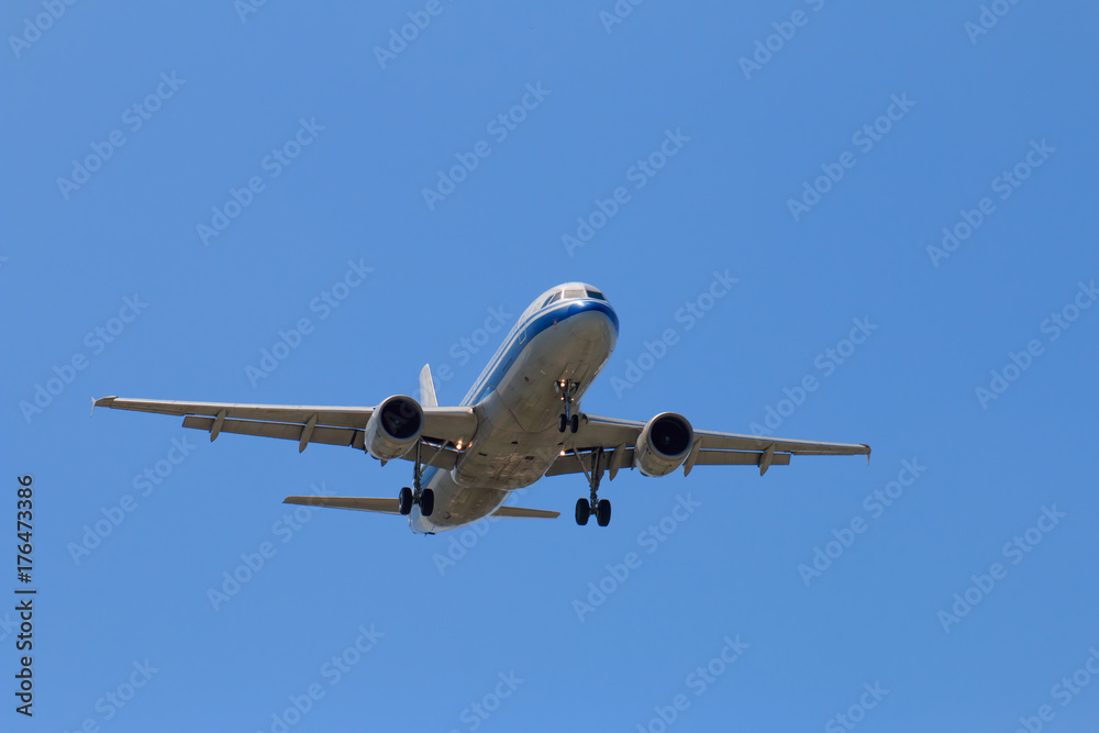 Fototapeta premium Passenger Airplane Taking Off Into The Blue Sky