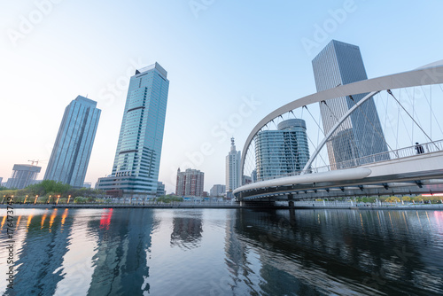 Tianjin city waterfront downtown skyline over Haihe river China.