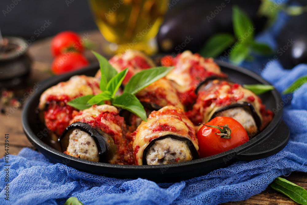 Eggplant (aubergine) rolls with meat in tomato sauce. Flat lay. Top view