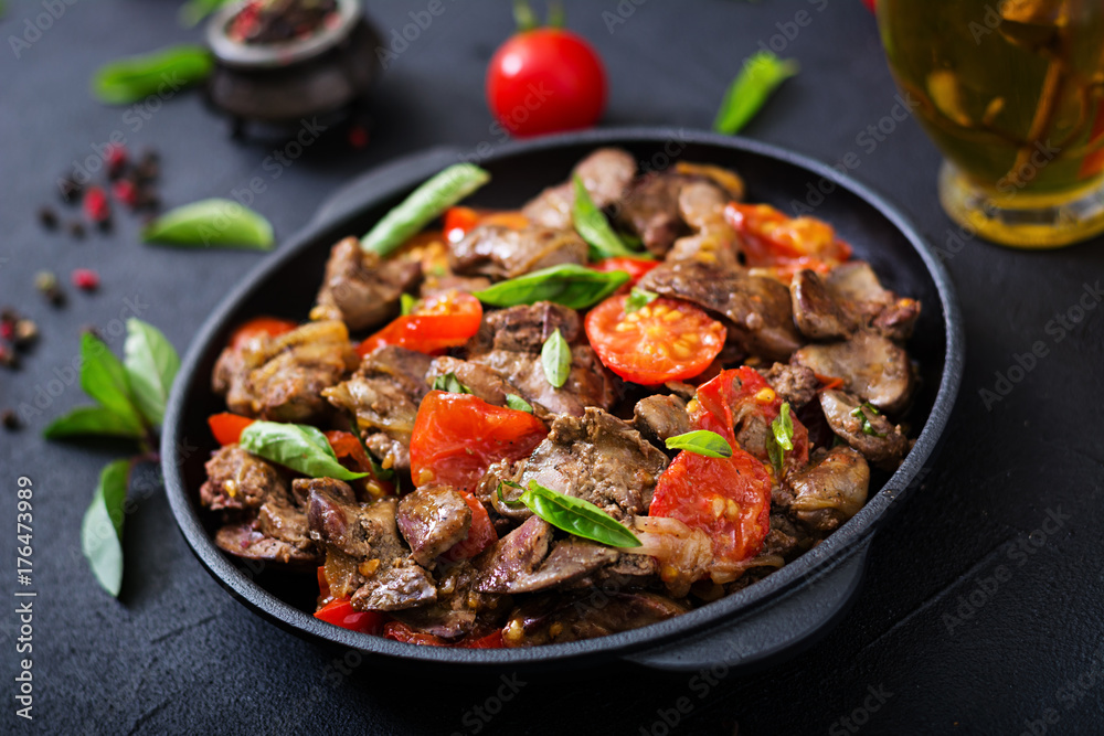 Chicken liver (offal) with onions and tomatoes in a frying pan in Armenian Chicken liver (offal) with onions and tomatoes in a frying pan in Armenian