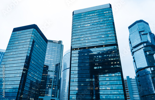 Obraz na płótnie directly below of modern financial skyscrapers in central Hong Kong,blue toned,china. w salonie