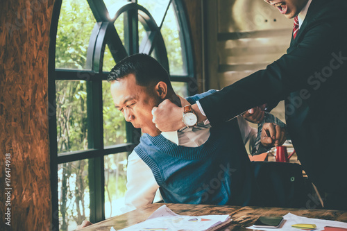 Businessman fighting with his coworker in office. photo