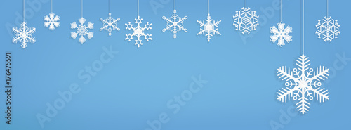 Winter Holiday Banner - Paper Snowflakes hanging on Blue wall