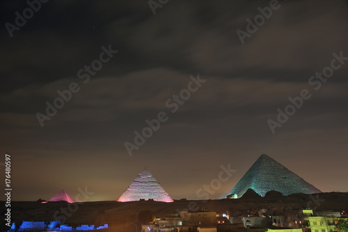 Dramatic sunset behind distant Egyptian pyramids in Giza, Cairo, Egypt