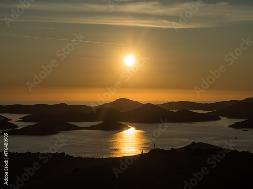 Aerial panoramic view of sunset above the islands in Croatia with many sailing yachts between, duak in Kornati national park landscape in the Mediterranean sea