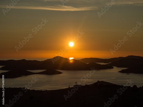 Aerial panoramic view of sunset above the islands in Croatia with many sailing yachts between, duak in Kornati national park landscape in the Mediterranean sea