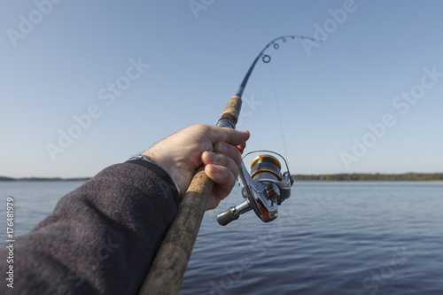 Fishing on a lake. clear blue sky.