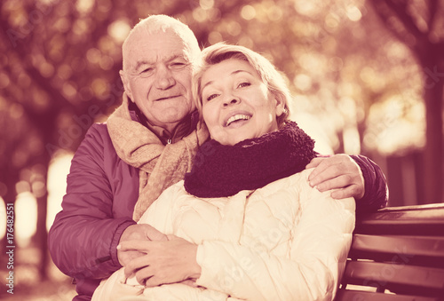 Mature couple sitting in park