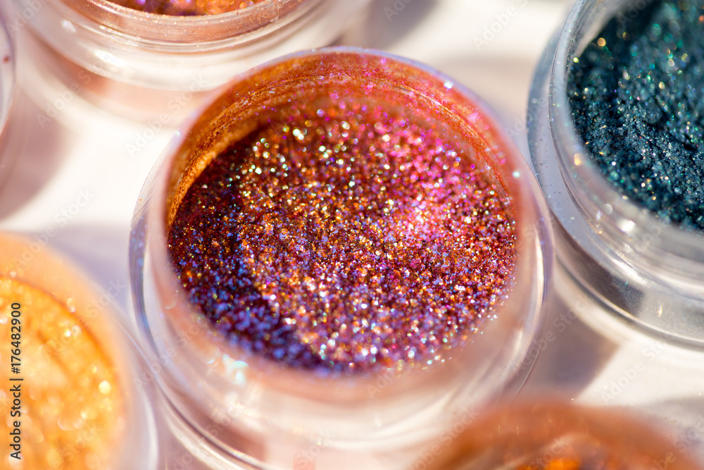 Cosmetics. Pigments for make-up, eyes, lips, face and body. Brilliant radiant, scattered multicolored powders. Cosmetics. Pigments for make-up, eyes, lips, face and body. Brilliant radiant, scattered multicolored powders.