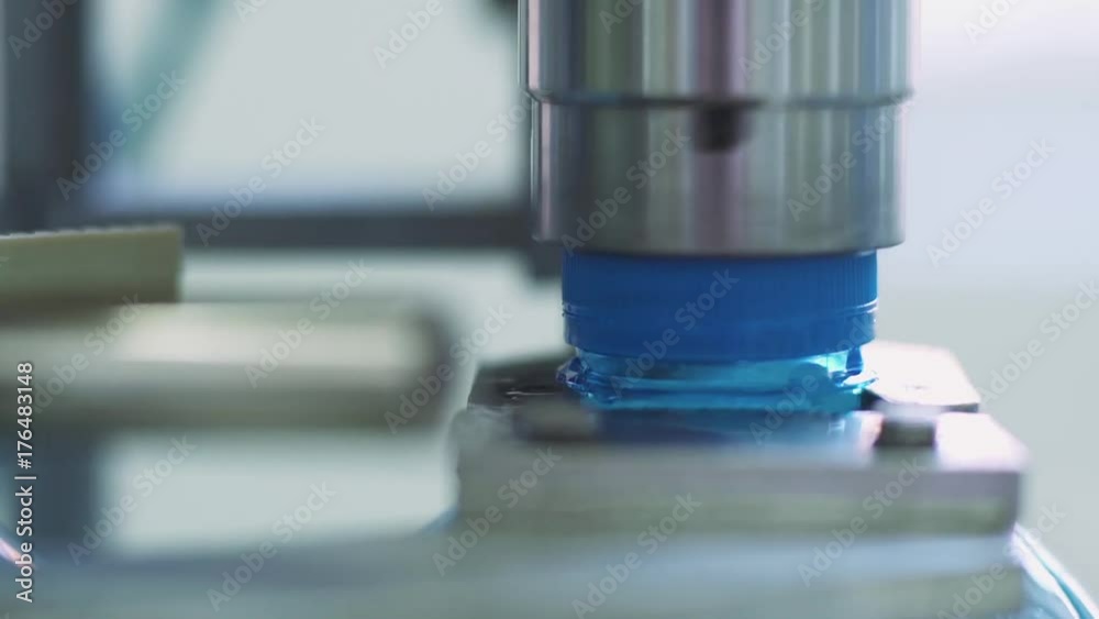 Production line of drinking mineral water and carbonated drinks, machine installs the lid on a plastic bottle, conveyor.
Production line of drinking mineral water and carbonated drinks, machine installs the lid on a plastic bottle, conveyor.