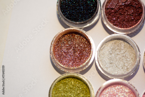 Cosmetics. Pigments for make-up, eyes, lips, face and body. Brilliant radiant, scattered multicolored powders.