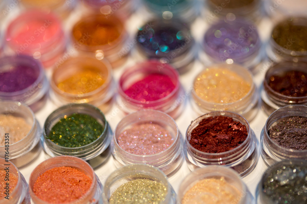 Cosmetics. Pigments for make-up, eyes, lips, face and body. Brilliant radiant, scattered multicolored powders.
