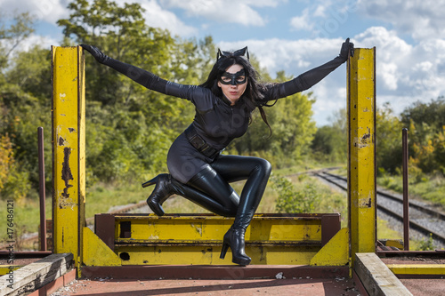 Woman in Catwoman costume on railroad waggon photo