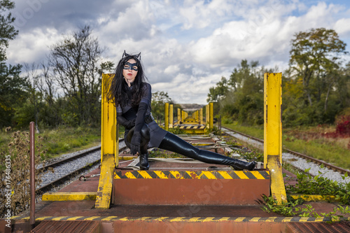 Woman in Catwoman costume on railroad waggon