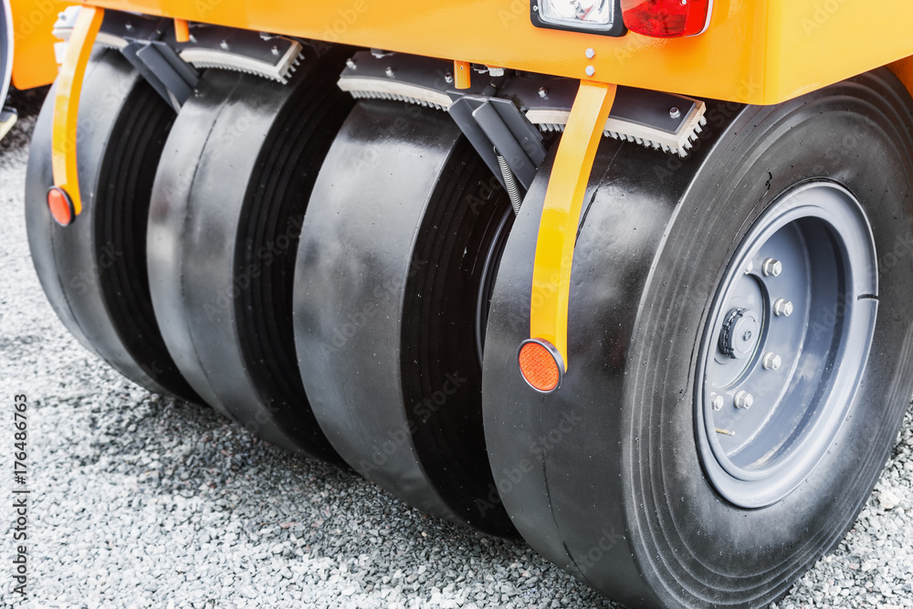 wheels of the tractor or roller of the paver. details of construction equipment and transport for repair of roads