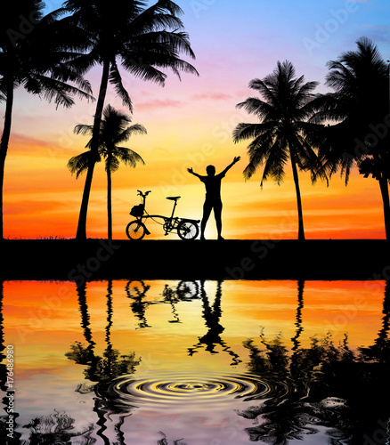 silhouette Sport man whit bike on blurry sunrise background