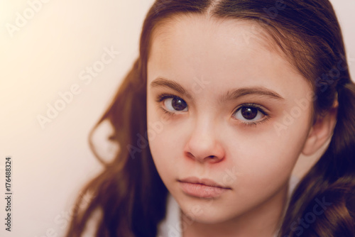 Portrait of charming kid that posing on camera