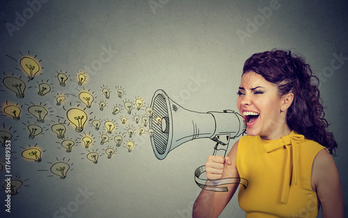 Business woman screaming out her ideas loud in megaphone