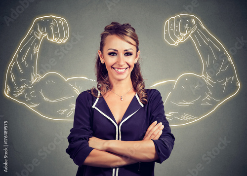 Strong happy young woman on gray background