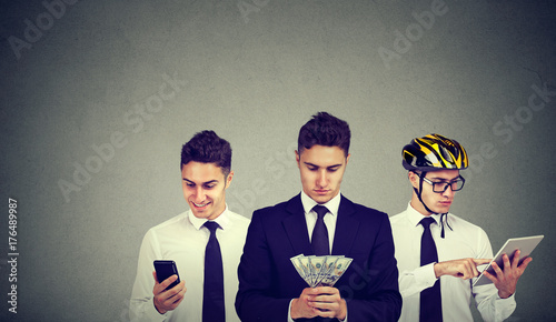 Young business man multitasking using mobile phone tablet computer counting money