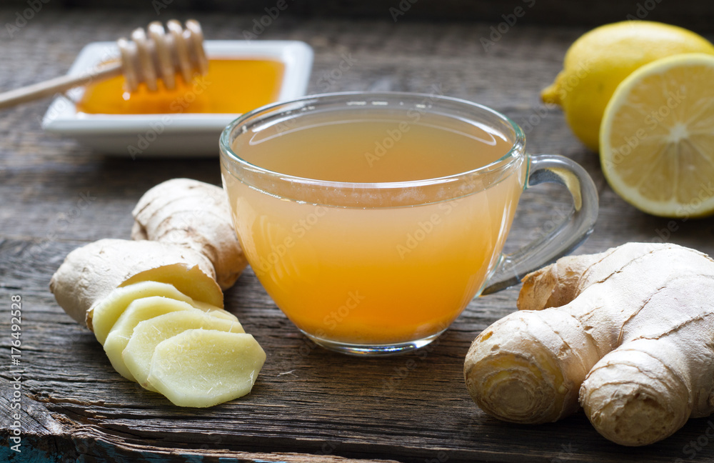 Ginger homemade tea infusion on wooden board with lemon
Ginger homemade tea infusion on wooden board with lemon