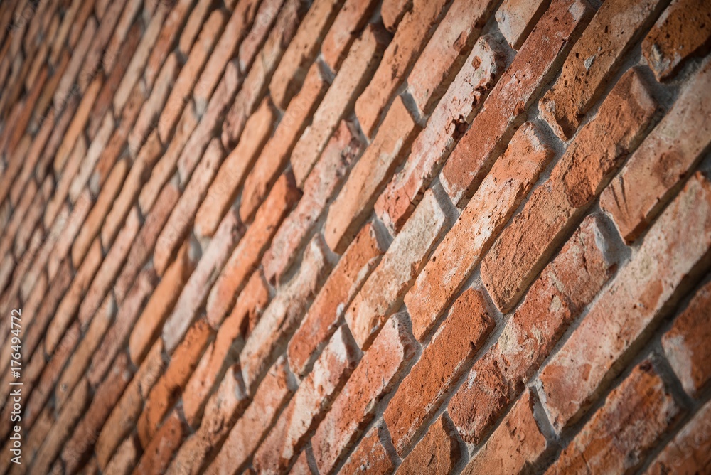 Red brick wall texture grunge background in perspective view. Selective focus
