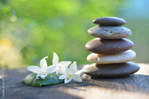 Zen stones spa with natural green background.