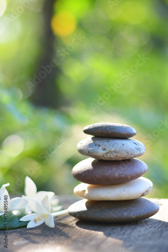 Zen stones spa with natural green background vertical.
