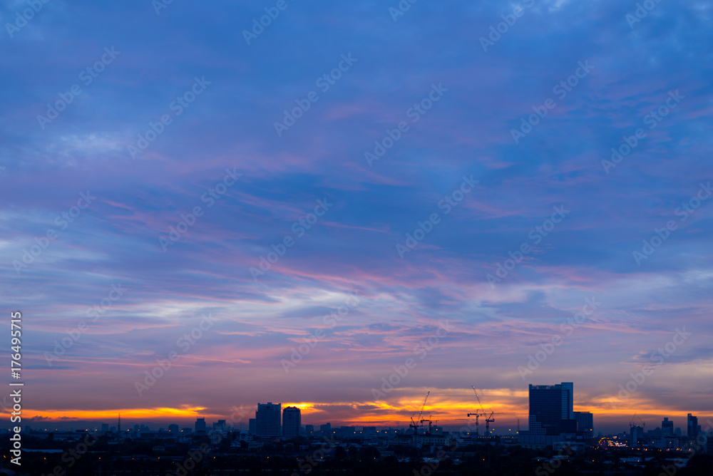 Abstract blur of amazing sunrise skyscape with silhouette city town with copy space, Bangkok, Thailand