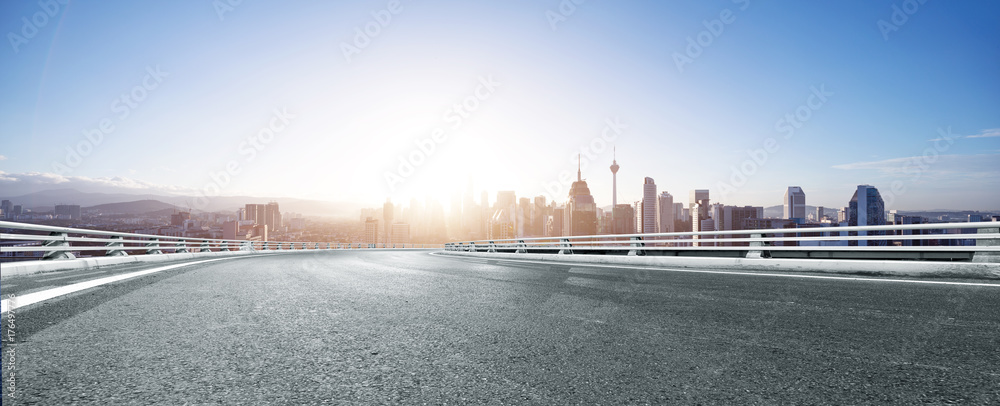 Fototapeta premium empty asphalt road with cityscape of modern city