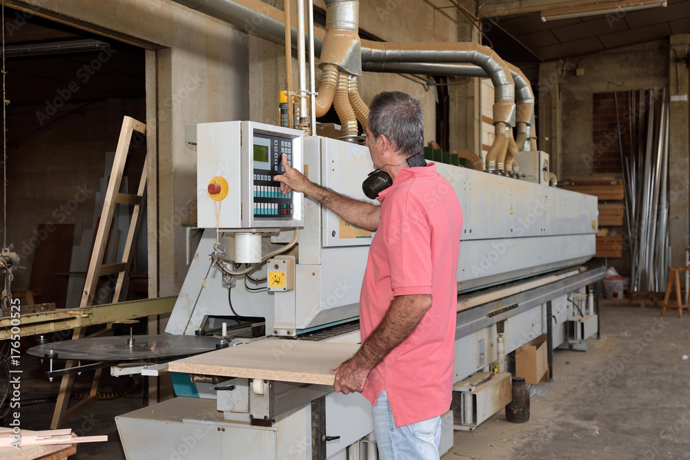 Fototapeta premium a carpenter who is programming a machine