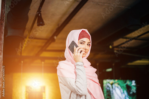 Muslim business woman on phone over conference photo