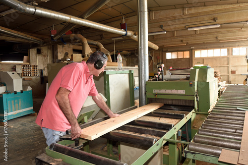 carpenter polishing wood in a carpentry workshop