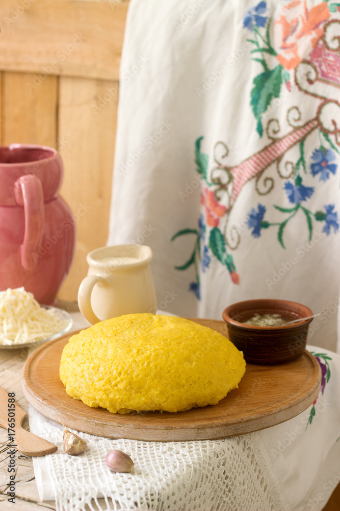Mamaliaga or polenta, a traditional dish of Moldovan, Romanian, Hungarian and Ukrainian cuisine. Porridge from corn flour. Served with brynza, sour cream and garlic sauce. Mamaliaga or polenta, a traditional dish of Moldovan, Romanian, Hungarian and Ukrainian cuisine. Porridge from corn flour. Served with brynza, sour cream and garlic sauce.