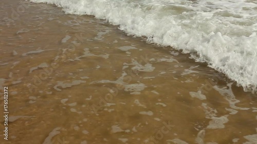 Tropical beach - waves hitting sand; steadicam footage, no people; South China Sea, Guangdong province, China photo