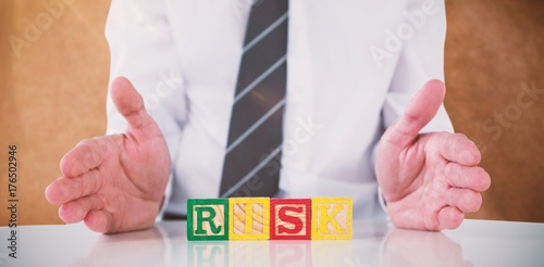 Composite image of mid section of businessman with risk text