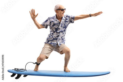 Senior surfing on a surfboard