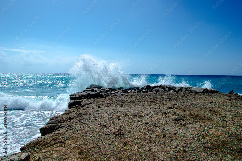 Fototapeta premium Waves break about a stone pier
