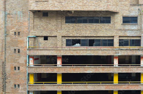 Old brick building with parking lot.  