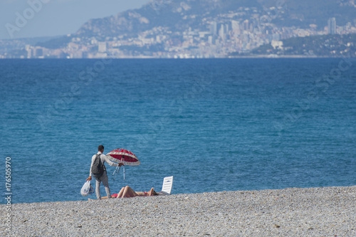 Italy,Liguria, peddler on the beach.