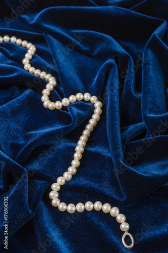string of pearls on blue velvet