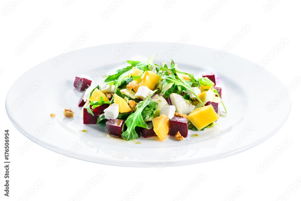 Delicious and appetizing salad with avocado, cheese and lettuce in a white plate isolated on white background. Autumn menu in an Italian restaurant. Photo for menu design