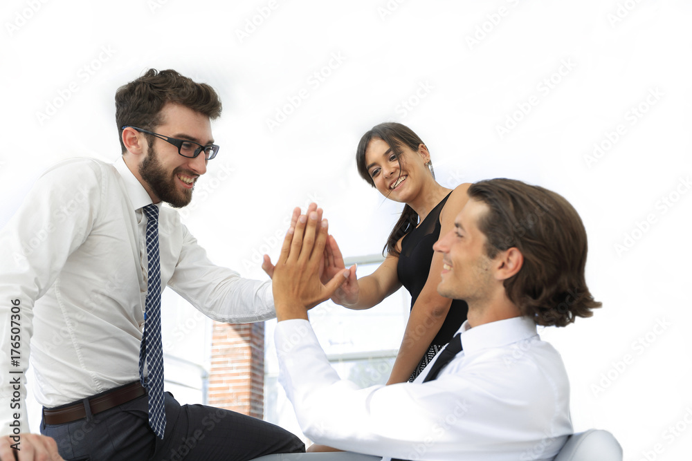 members of the business team give each other high five members of the business team give each other high five