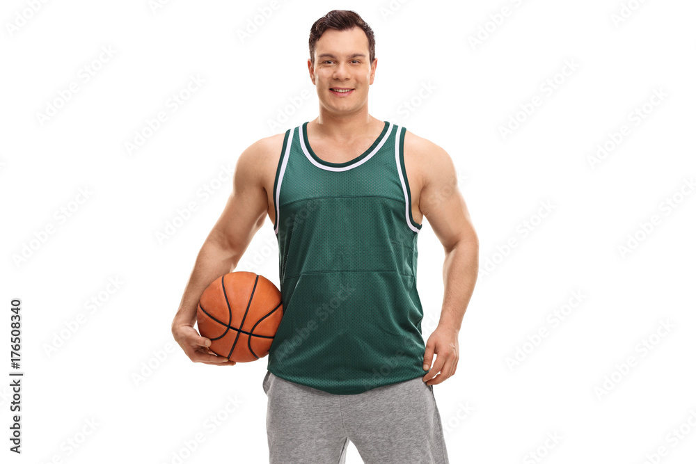 Obraz premium Young man dressed in a green jersey holding a basketball