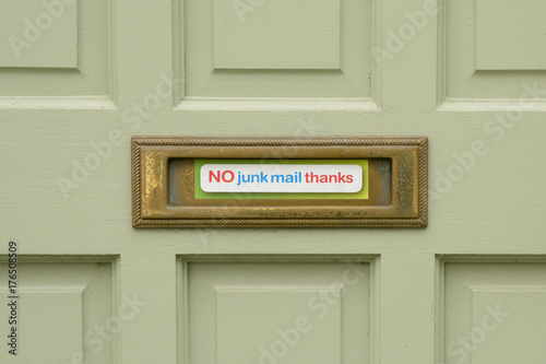 No Junk Mail thanks sign stuck to letterbox on door of house